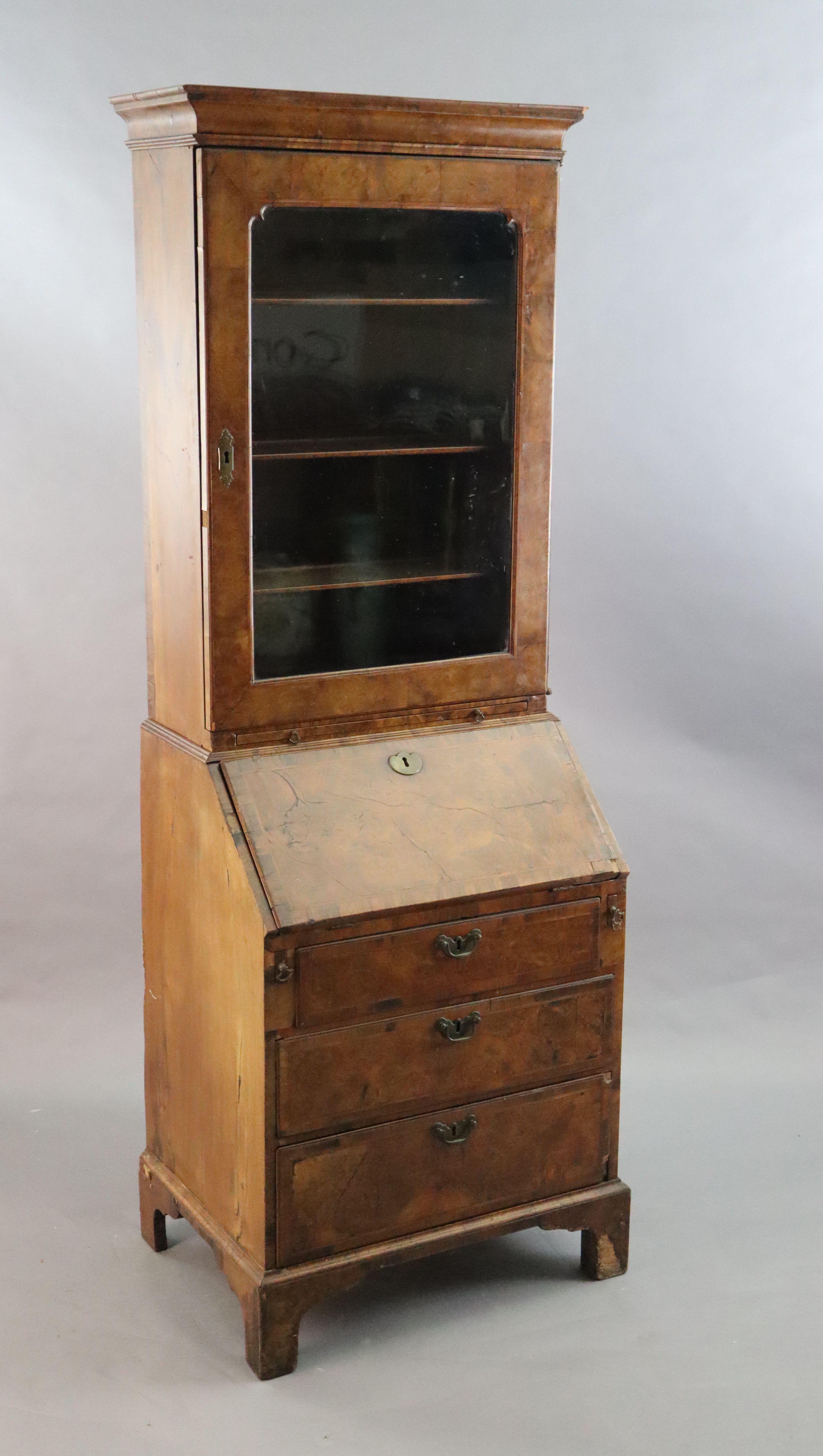 An early 18th century banded walnut bureau bookcase W. 2ft 4in. H. 6ft 6in. D. 1ft 8in.